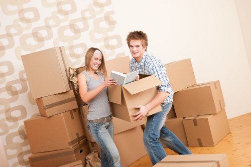 Packed moving boxes and furniture ready for transport in Elmersend